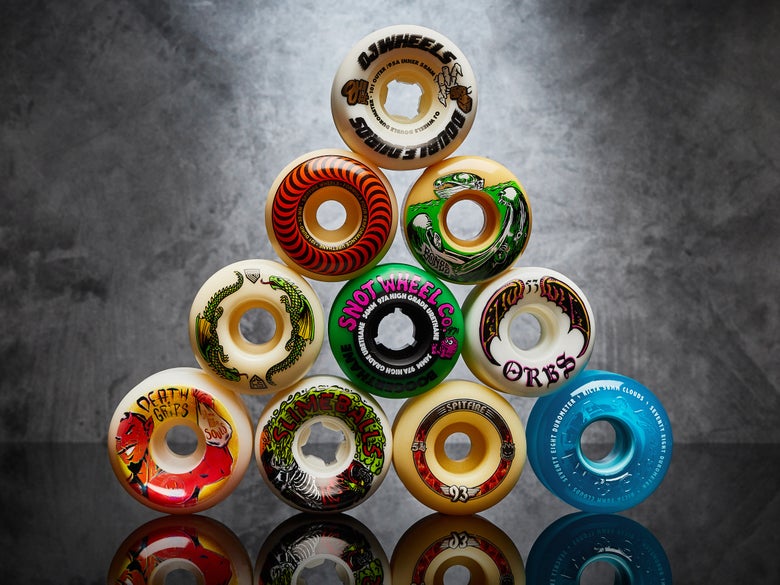 Various skateboard wheels stacked on top of each other.