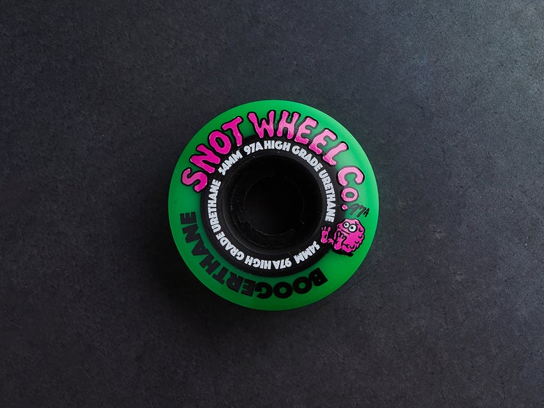 A green Snot Boogerthane skateboard wheel.