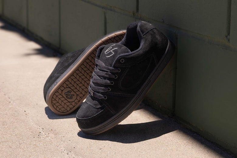 éS Accel OG Shoes, leaned up against a wall.