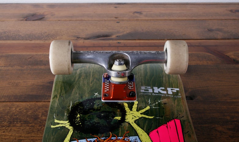 Wheels and trucks on a skateboard deck.